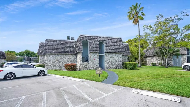an aerial view of a house with a backyard and a fireplace