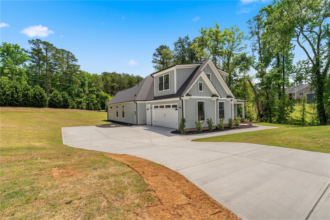 203 Timothy Court Anderson, SC 29621 - Photo 25 of 40 A newly constructed residence features ample yard space, an attached garage, and a long concrete driveway.