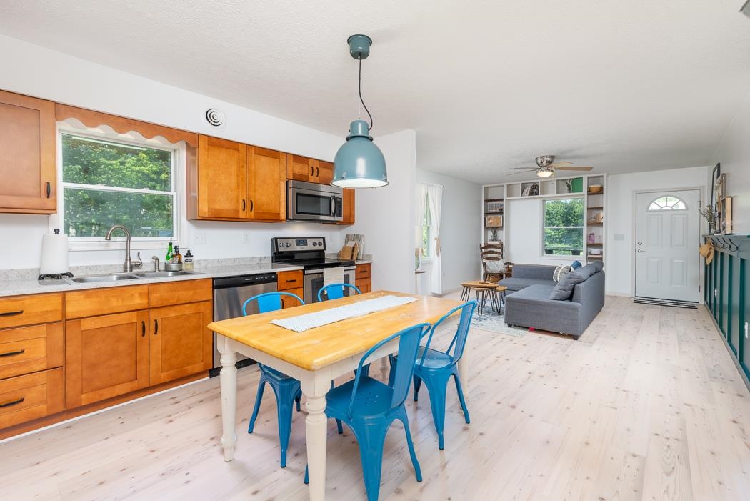 471 Shirey Road Swoope, VA 24479 - Photo 26 of 75 a kitchen with stainless steel appliances granite countertop a stove top oven a sink dishwasher and a dining table with granite countertops
