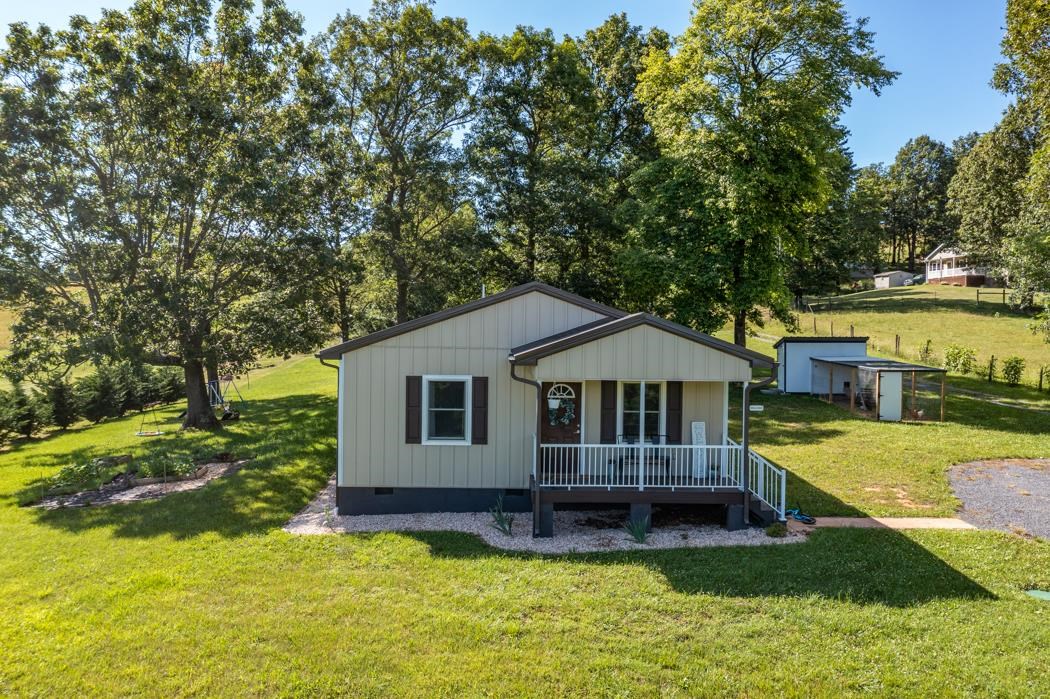 471 Shirey Road Swoope, VA 24479 - Photo 3 of 75 a house that has a big yard with plants and large trees