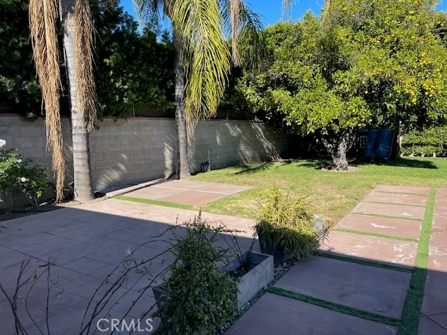 a view of a white house with a yard