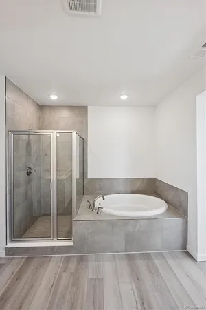 a bathroom with a bathtub and a shower