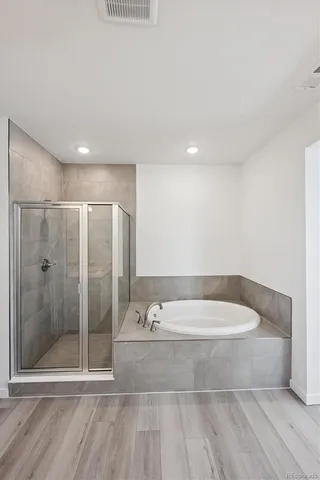 a bathroom with a bathtub and a shower