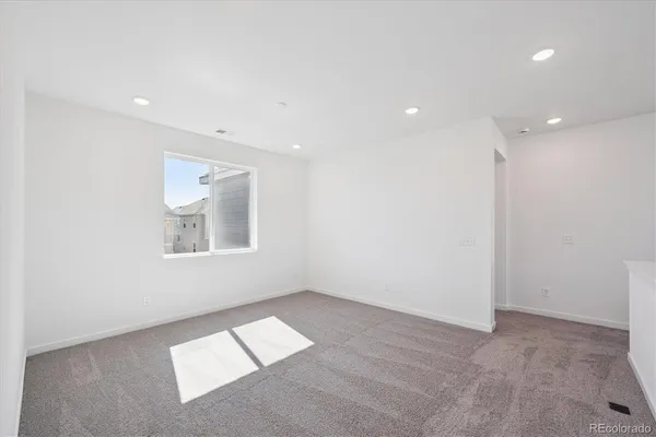 a view of an empty room with a kitchen