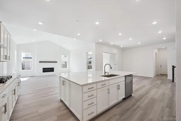 a kitchen with a sink stove and cabinets