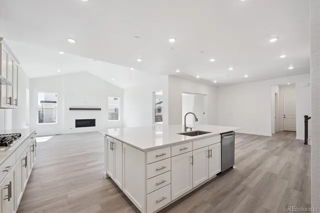 a kitchen with a sink stove and cabinets