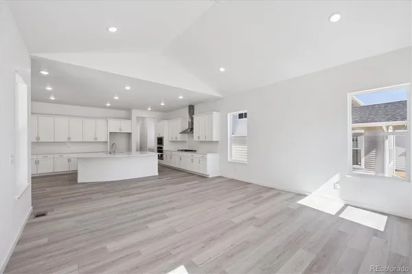a view of kitchen with kitchen island wooden cabinets and center island