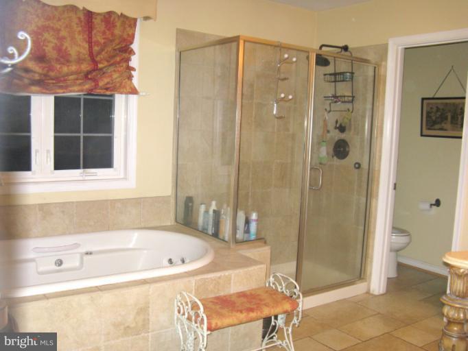 310 Greenwood Road Linthicum, MD 21090 - Photo 14 of 26 a bathroom with a tub and a shower