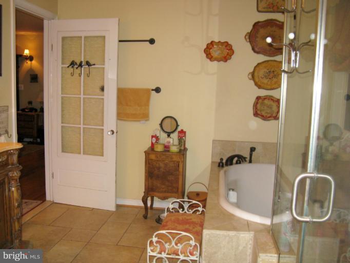 310 Greenwood Road Linthicum, MD 21090 - Photo 15 of 26 a bathroom with a tub and shower