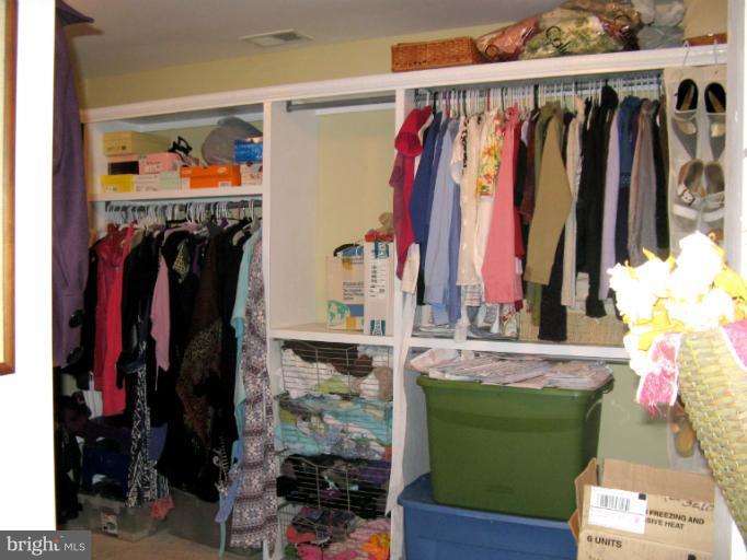 310 Greenwood Road Linthicum, MD 21090 - Photo 17 of 26 a view of walk in closet with clothes and shoes