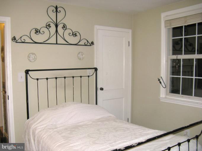 310 Greenwood Road Linthicum, MD 21090 - Photo 18 of 26 a bedroom with a bed and a window