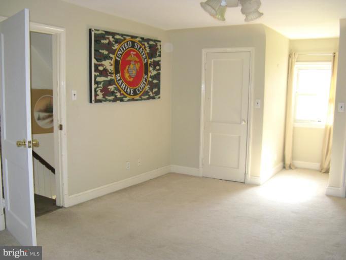 310 Greenwood Road Linthicum, MD 21090 - Photo 21 of 26 a view of an empty room with a painting on the wall