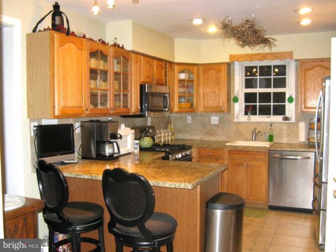 310 Greenwood Road Linthicum, MD 21090 - Photo 4 of 26 a kitchen with a refrigerator and a stove top oven