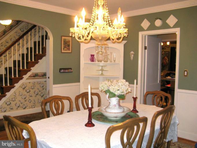 310 Greenwood Road Linthicum, MD 21090 - Photo 9 of 26 a dining room with furniture a chandelier and wooden floor