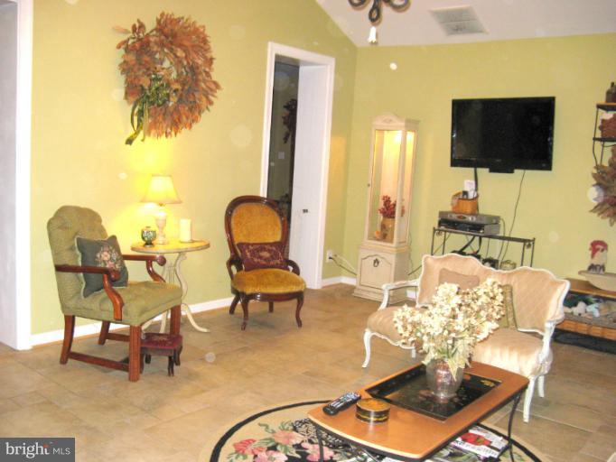 310 Greenwood Road Linthicum, MD 21090 - Photo 10 of 26 a living room with furniture and a flat screen tv