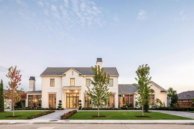 a front view of a house with a yard table and chairs