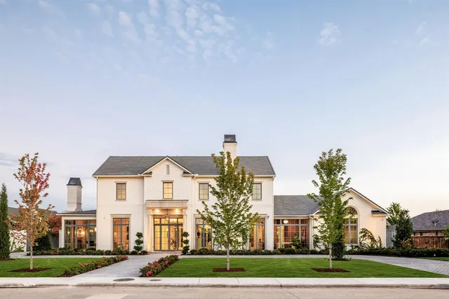 a front view of a house with a yard table and chairs