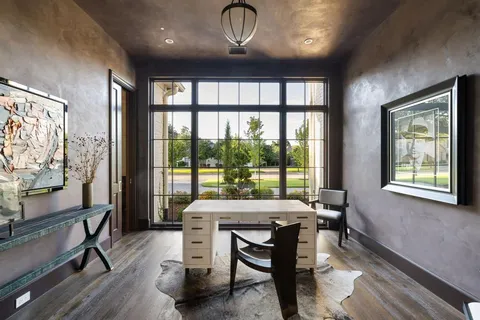 a spacious bathroom with a granite countertop sink vanity mirror bathtub and next to a window