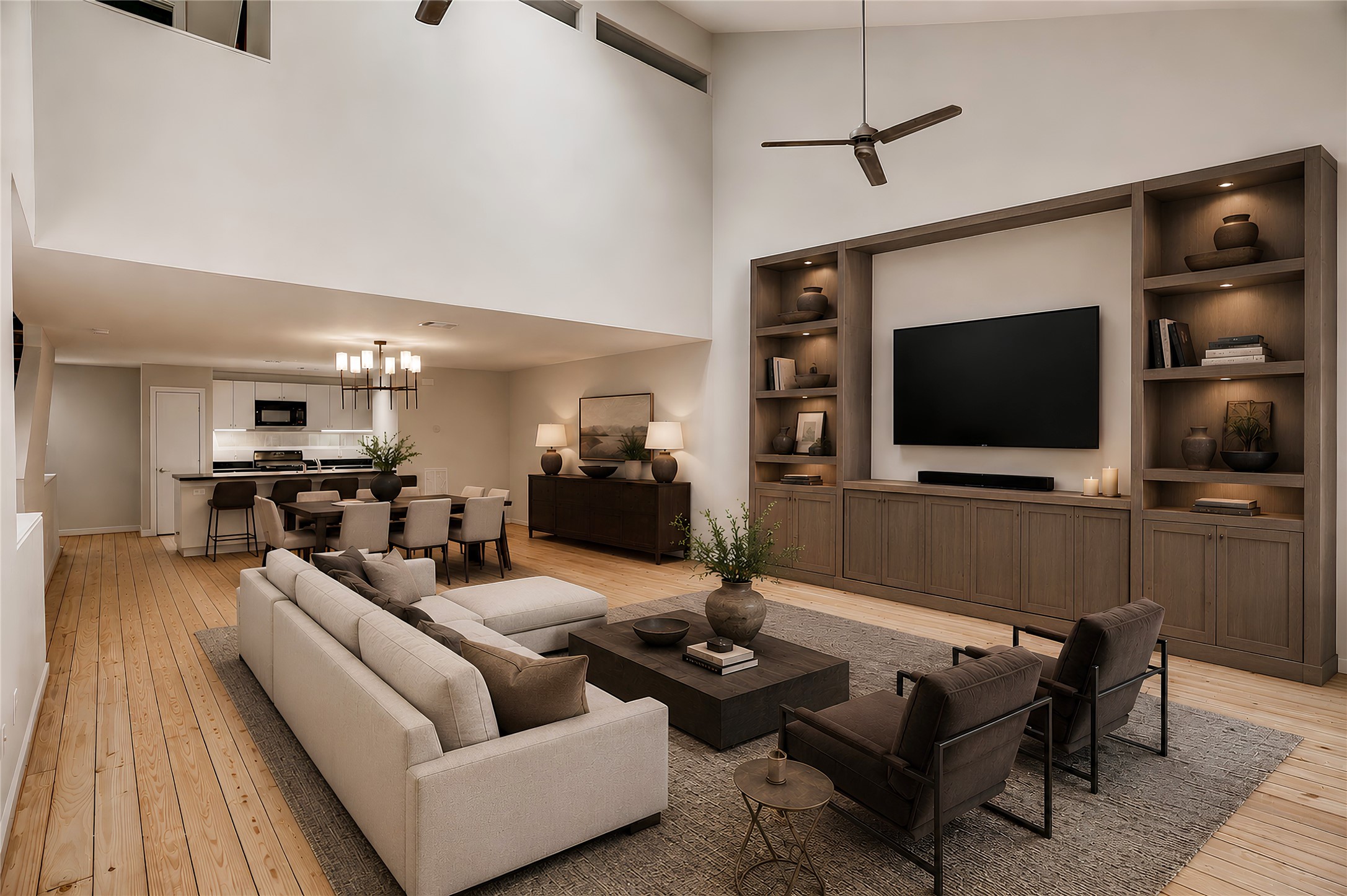 910 Ruthven Street Houston, TX 77019 - Photo 7 of 35 Another virtual staging view of the living room, note the cathedral ceiling, two fans, track lights, and open to dining room. Above you’ll see a balcony overlooking the living room from the primary.