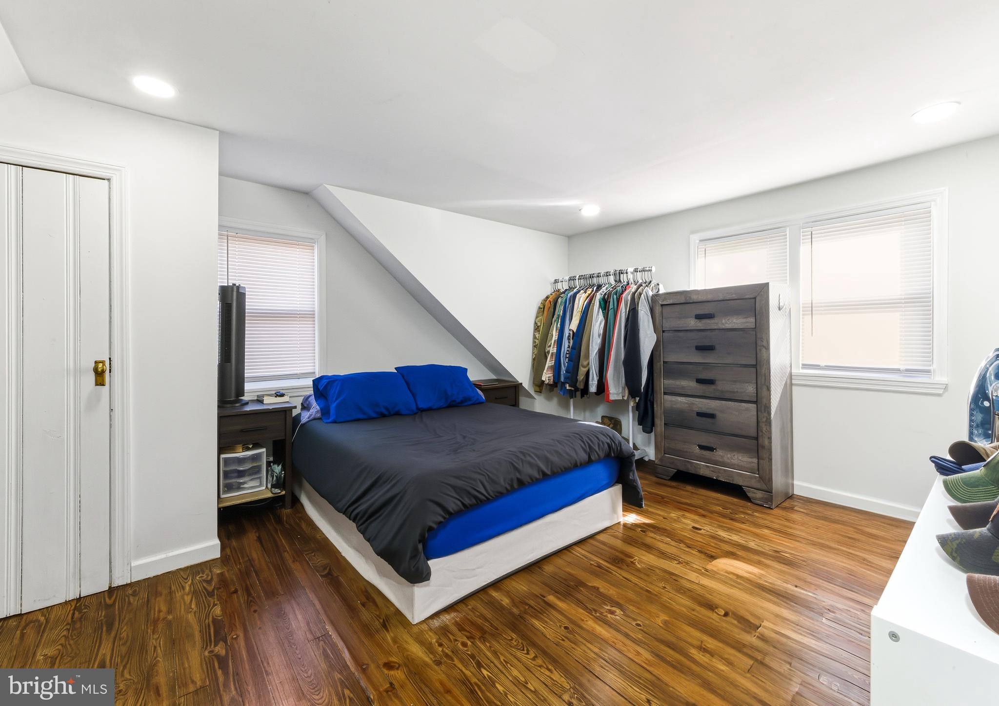 1287 Clements Bridge Road Woodbury, NJ 08096 - Photo 13 of 16 a living room with a bed furniture and a window