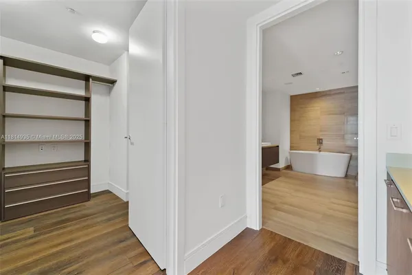 a view of a room with wooden floor