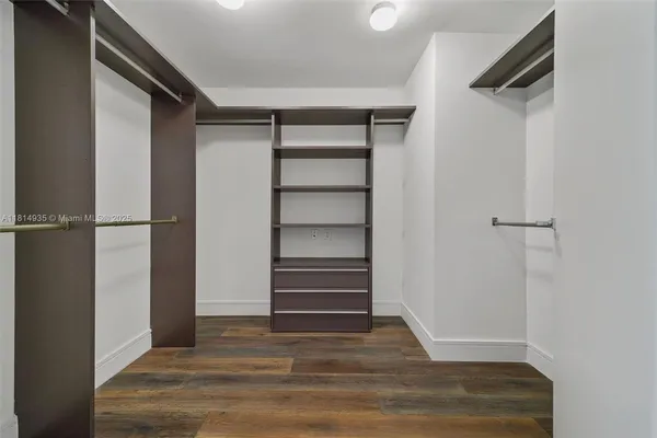a view of walk in closet with empty racks