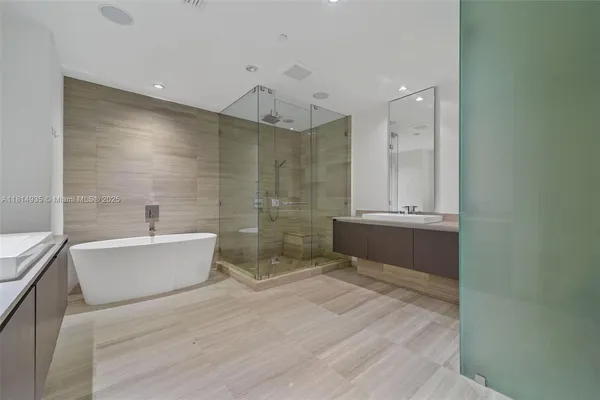 a bathroom with a bathtub a sink and a shower
