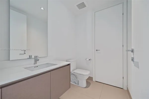 a bathroom with a sink toilet and vanity