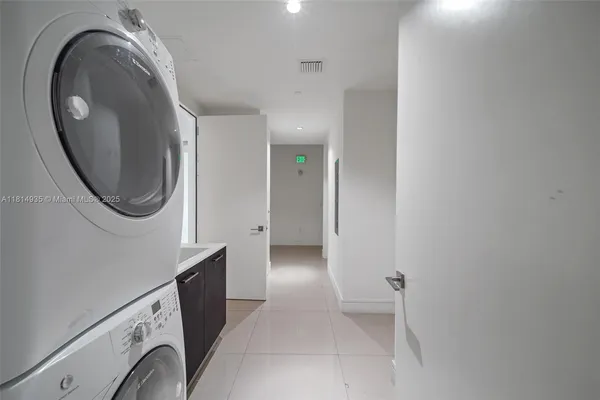 a view of a hallway with washer and dryer