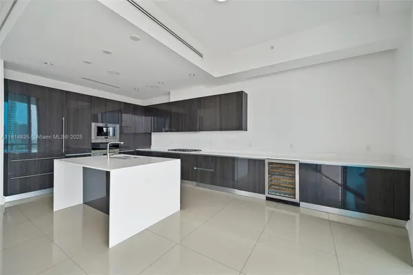 a kitchen with stainless steel appliances a stove top oven and cabinets
