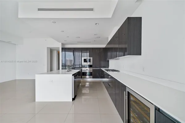 a kitchen with stainless steel appliances a stove a sink and a refrigerator