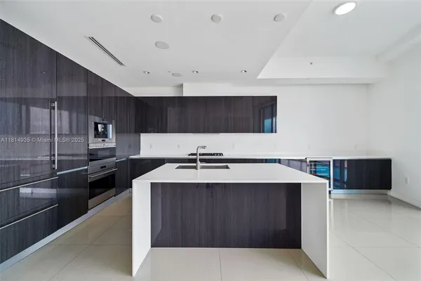 a kitchen with a cabinets and stainless steel appliances