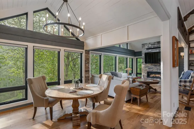 a view of a dining room with furniture large windows and wooden floor
