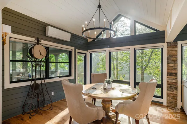 a view of a dining room with furniture wooden floor and chandelier