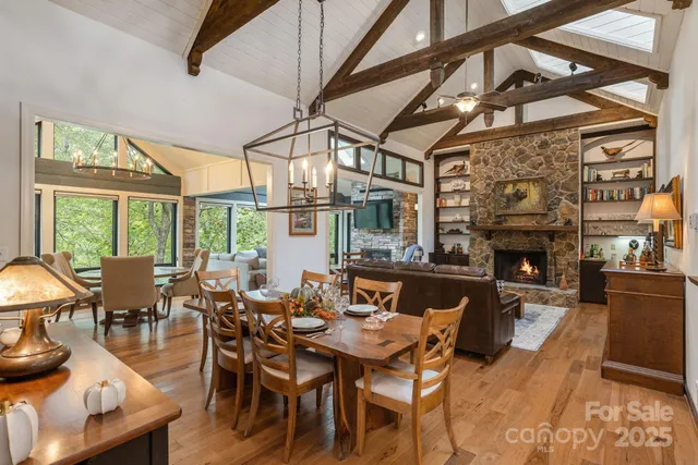 a dining room with furniture a fireplace and wooden floor