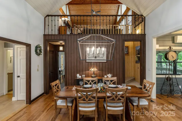 a view of a dining room with furniture and chandelier