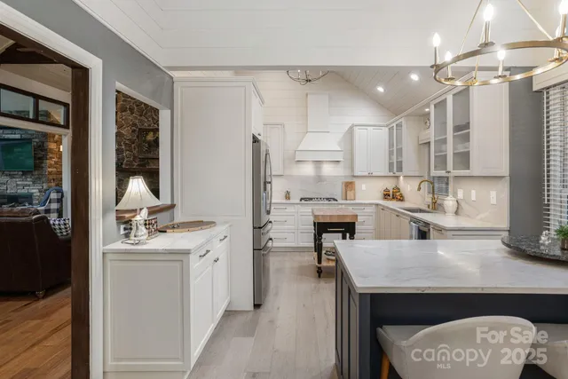 a kitchen with a sink a stove and chairs
