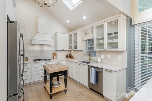 a kitchen with a stove a sink and a refrigerator