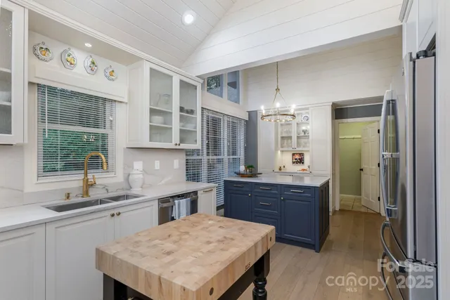 a kitchen with a stove a sink a dining table and chairs