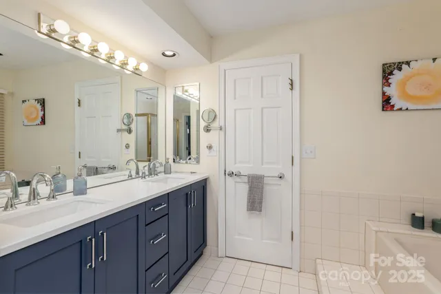 a bathroom with a double vanity sink mirror and