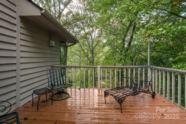 a view of balcony with wooden floor and outdoor seating