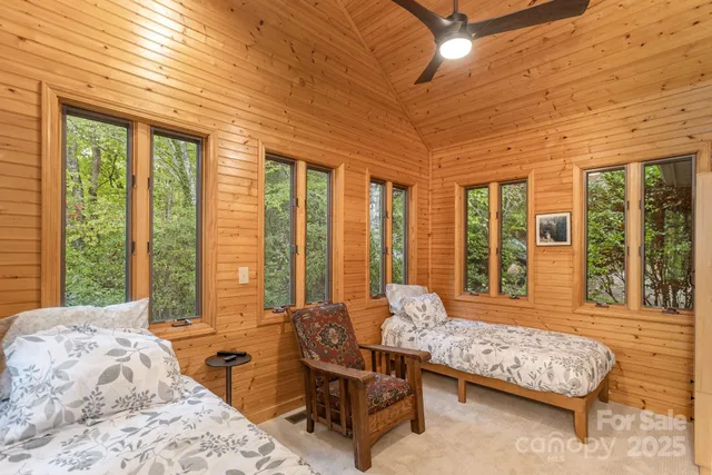 a bedroom with furniture and large windows