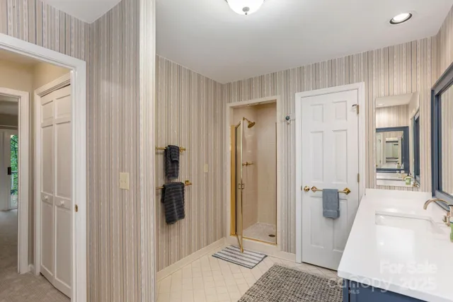 a bathroom with a sink and glass door