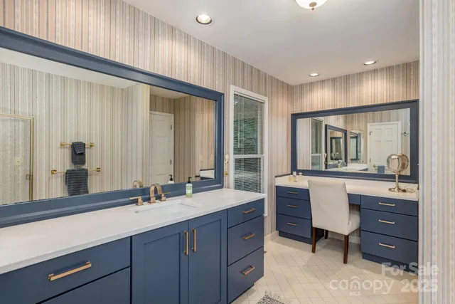 a bathroom with a sink double vanity and a large mirror