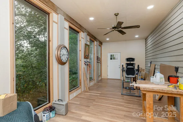 a view of a hallway with dining room and wooden floor