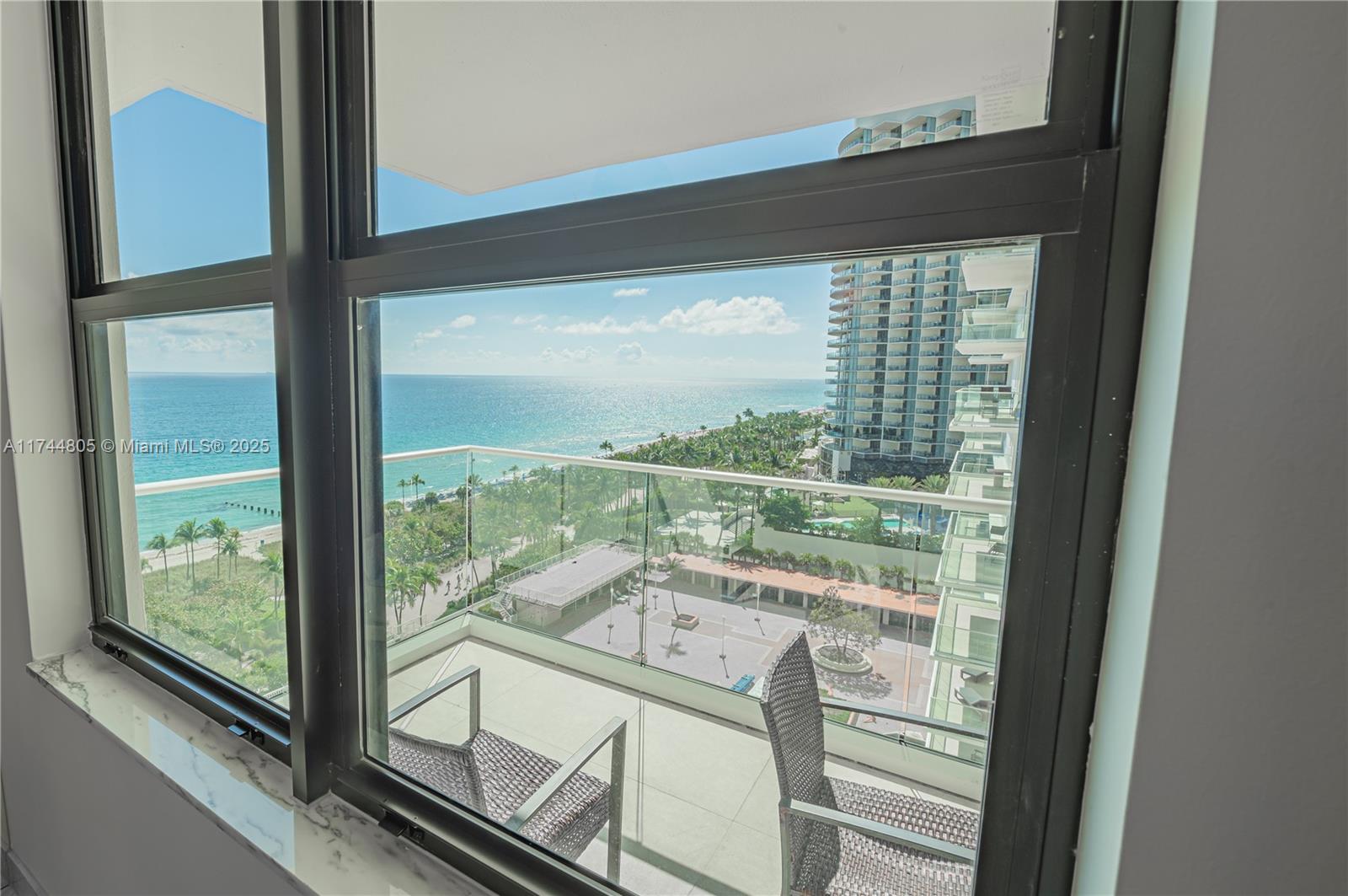 9801 Collins Avenue, Unit 14D Bal Harbour, FL 33154 - Photo 11 of 25 a view of a glass door with a view from a balcony