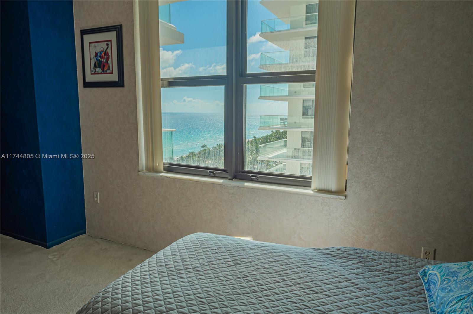 9801 Collins Avenue, Unit 14D Bal Harbour, FL 33154 - Photo 16 of 25 a bedroom with a bed and a window