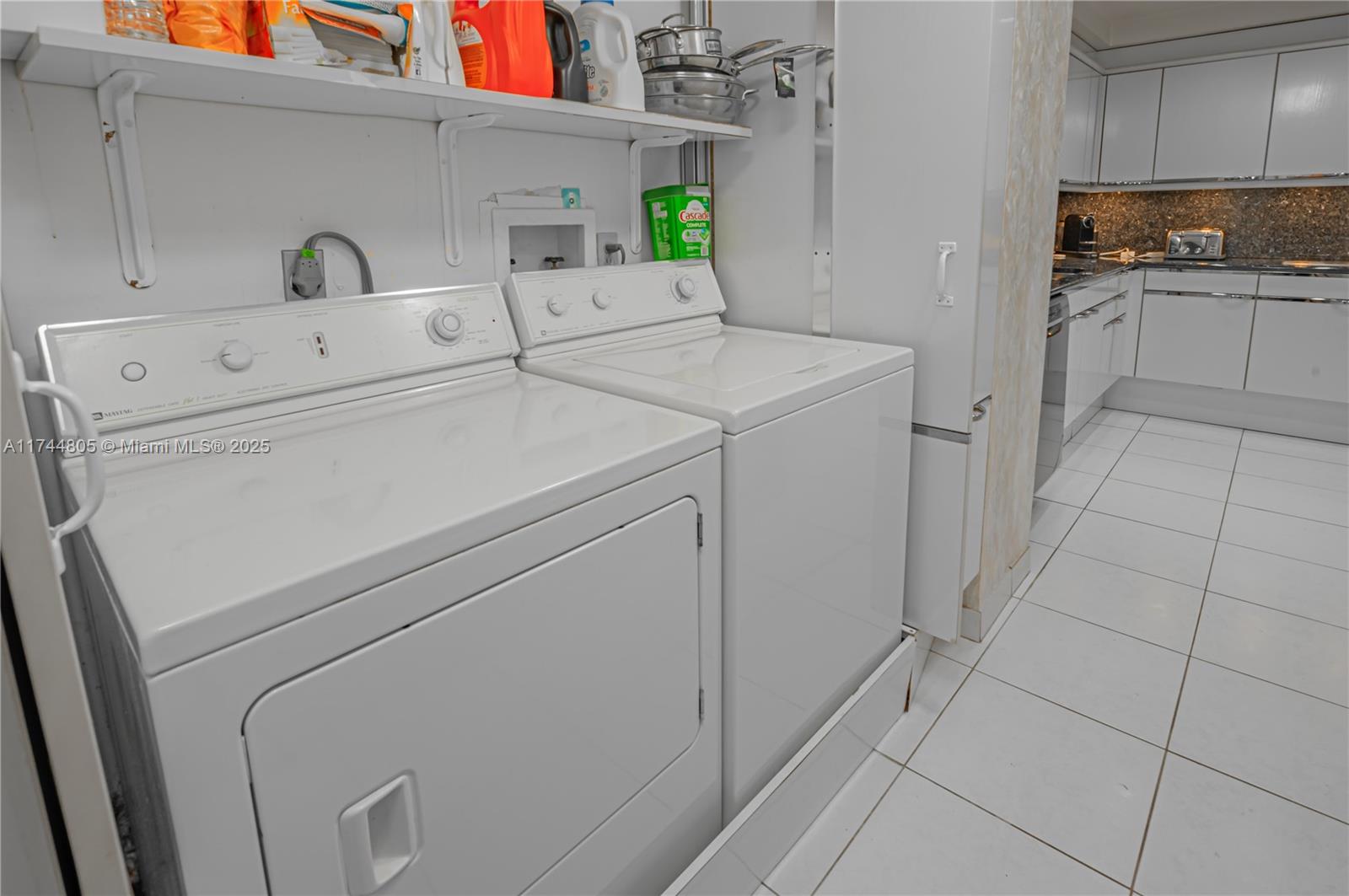 9801 Collins Avenue, Unit 14D Bal Harbour, FL 33154 - Photo 9 of 25 a utility room with dryer and washer
