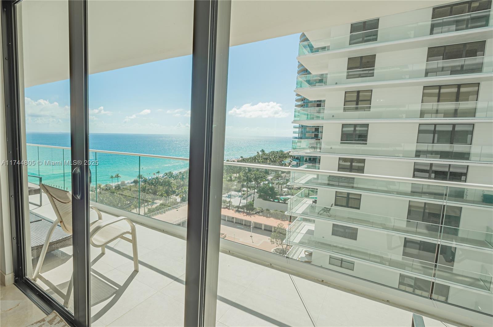 9801 Collins Avenue, Unit 14D Bal Harbour, FL 33154 - Photo 10 of 25 a view of a glass building from a window