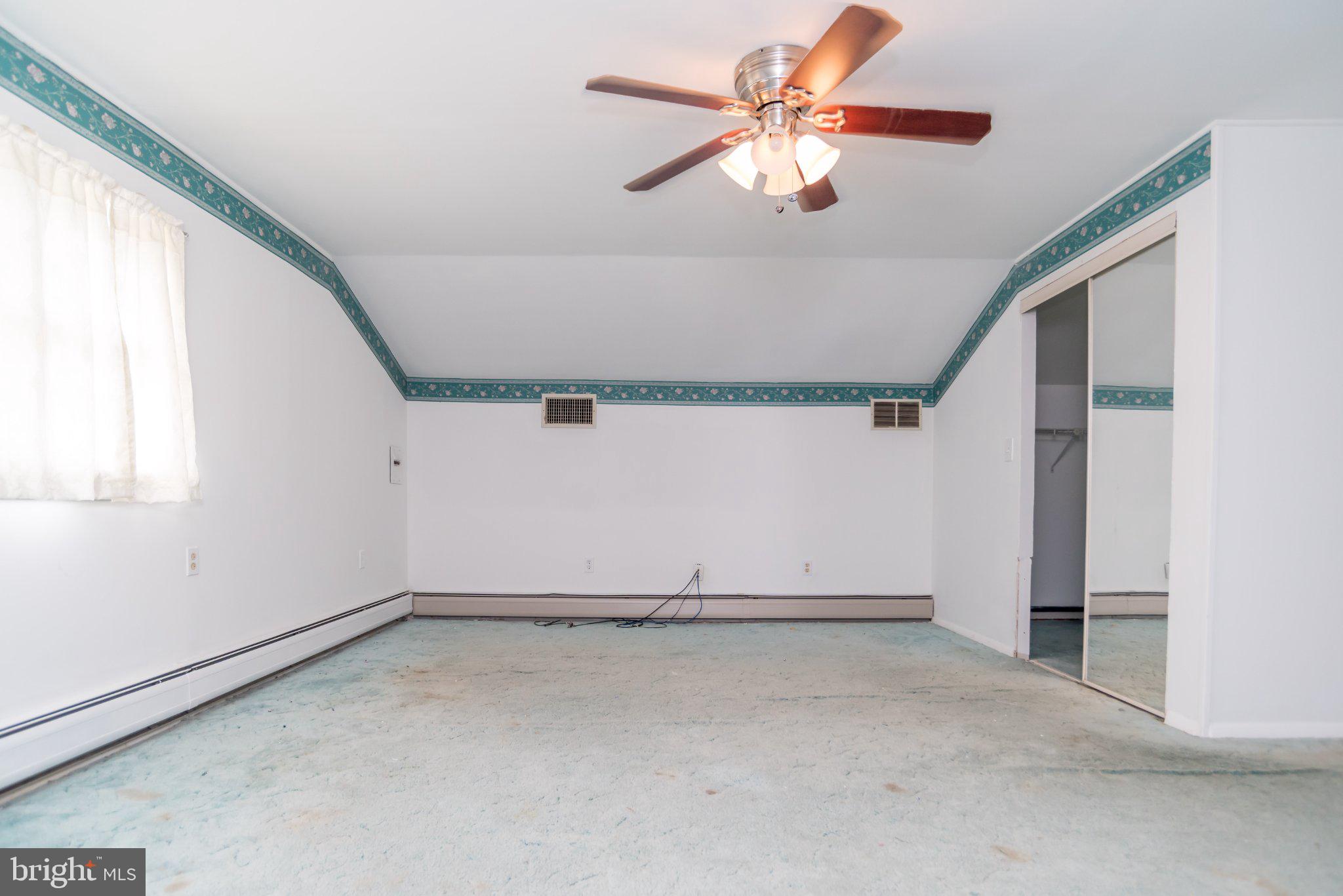 77 Cardinal Road Levittown, PA 19057 - Photo 25 of 37 an empty room with a ceiling fan and window
